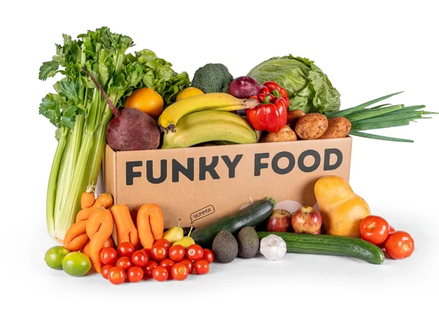 Funky Food cardboard box overflowing with fruit and vegetables.