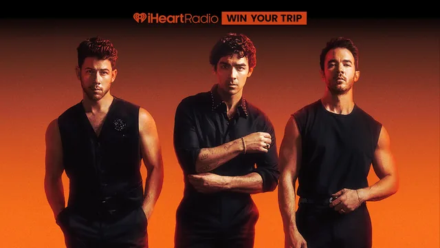iHeartRadio promotional graphic for the Holiday with the Jonas Brothers sweepstakes showing the three Jonas Brothers against an orange background with the words «Win your trip».