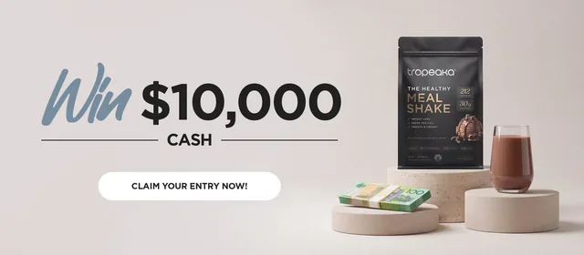 Tropeaka banner reading Win $10,000 cash, with a pack of Tropeaka meal shake, a glass and a stack of banknotes.